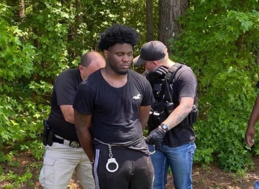 Law enforcement officials take Demarquese Gibson, 20, of Grenada into custody in Louisville on Wednesday. Officials said Gibson, who was being transported to the Winston County Jail on a grand larceny charge escaped on Tuesday.